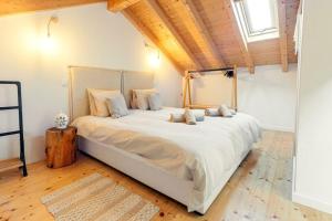 1 cama blanca grande en una habitación con techo de madera en Casa elegante em Vila tranquila, en Barão de São Miguel