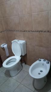 łazienka z toaletą i umywalką w obiekcie Casa festival Jesús María w mieście Colonia Caroya