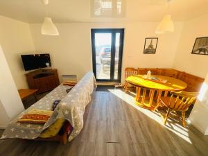 a living room with a couch and a table at Résidence Le Clos Saint-Savin in Font-Romeu-Odeillo-Via