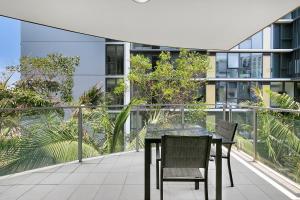 a table and chairs on the balcony of a building at South bank Serviced Apartments in Brisbane