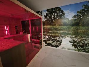 a bathroom with a large painting of a lake at Edit Villa Friends in Matrafured