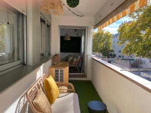 an outdoor balcony with a couch and a table at Dolce Terrassa 25 min Barcelona and Beach in Terrassa