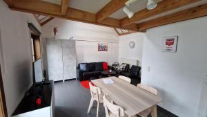 a living room with a table and a couch at Vissershuisje 89 te Wenduine in Wenduine