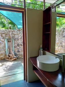 a bathroom with a white sink and a window at Balenbouche Estate in Laborie