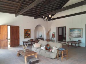 a living room with a couch and a table at Terra - Casa de Campo in Cachí