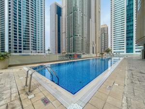 a swimming pool in a city with tall buildings at LUXFolio Retreats - Amazing Marina Location in Dubai