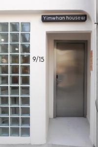 a door in a building with a sign for a window house at Yimwhan House 02, Ayutthaya old town in Phra Nakhon Si Ayutthaya