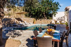 a patio with a table and chairs next to a pool at Villa Can Abrines in Lloseta