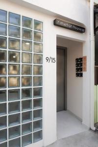 a door with glass panels on the side of a building at Yimwhan House 02, Ayutthaya old town in Phra Nakhon Si Ayutthaya