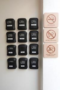 a black keyboard on a wall with no smoking signs at Yimwhan House 02, Ayutthaya old town in Phra Nakhon Si Ayutthaya