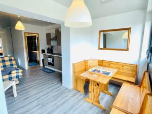 a living room with a table and a couch at Résidence Le Clos Saint-Savin in Font-Romeu-Odeillo-Via +17 photos