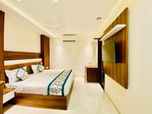 a hotel room with a bed and a television at Hotel White house near Golden Temple in Amritsar