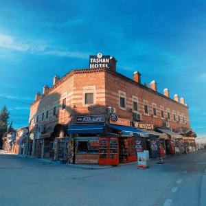 a brick building with a sign on the top of it at Taşhan Hotel in Edirne