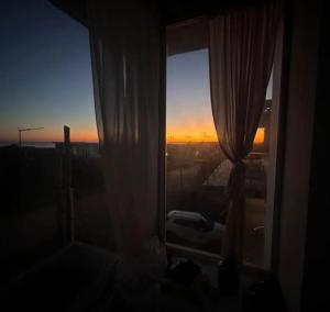a window in a room with a view of the sunset at Malujoseignacio in José Ignacio