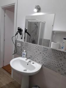 a bathroom with a sink and a mirror at Milazzo La Porta Delle Eolie 2.0 in Milazzo