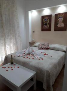 a bedroom with a bed with red roses on it at Milazzo La Porta Delle Eolie 2.0 in Milazzo