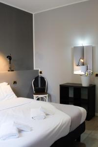 a hotel room with a bed and a chair at Hp Fly Hotel Bologna in Calderara di Reno