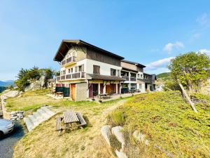 a house on the side of a hill with a car at Résidence Le Clos Saint-Savin in Font-Romeu-Odeillo-Via