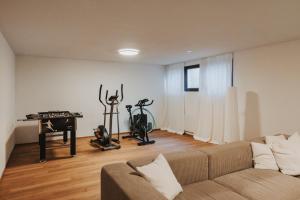 a living room with a couch and two exercise bikes at Haus A Ankommen-Abschalten-Auftanken in Bregenz