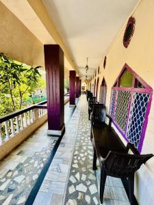 a balcony with benches on a balcony at Hotel New Sun N Rock ( 1km from Nakki Lake ) in Mount Ābu