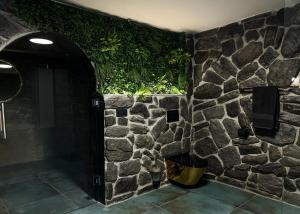 a room with a stone wall with a doorway at Golden Pinpoint in Gornje Vratno