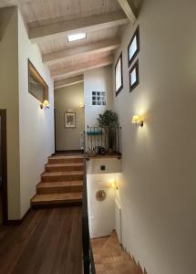 a hallway with a stairway with a stair case at Casa Rural Negua en La Cuenca, Soria in La Cuenca