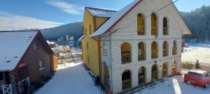 a building with a van parked in front of it at "Як вдома" Буковель in Bukovel