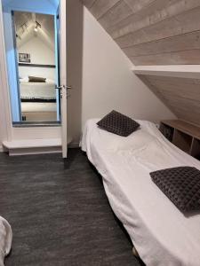 a bedroom with a bed and a door with a mirror at Lepadaloft in Villeneuve-Saint-Georges