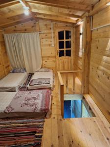 a room with two beds in a wooden cabin at Life camp in Nuweiba