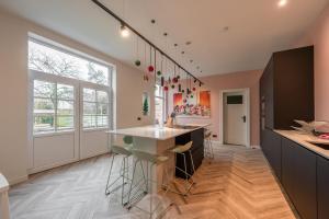 a kitchen with a island and a large window at Villa Cézar - big house at the center of Bruges - free parking in Bruges