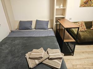 ein Schlafzimmer mit einem Bett mit Handtüchern darauf in der Unterkunft HOME20GEDV in Vilnius
