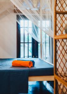 - un oreiller orange sur un lit superposé dans un dortoir dans l'établissement Villa Ali, à Galle