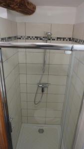 a shower with a glass door in a bathroom at L'Esprit du vallon de Berlou in Berlou