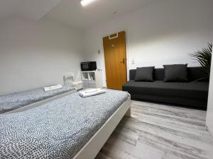 a living room with two beds and a couch at Apartment R41 in Essen