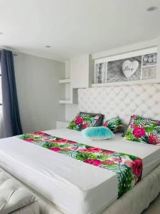 a large bed with pillows on it in a bedroom at Meliyer cheerful 3 bedrooms villa at perebere in Pereybere