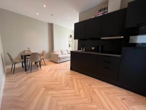 a living room with a kitchen and a dining room at Old Town City Centre Apartment 2 in Nijmegen