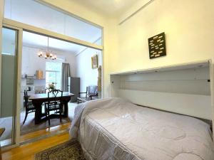 a bedroom with a bed and a dining room with a table at La Platea de Bs As [2A1] Live by the CCK. in Buenos Aires