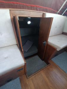 an open compartment on a boat with two seats at Django in Capestang