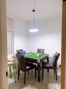 a dining room with a table and chairs with a chessboard at 梧同包棟民宿La Petite Maison in Tainan