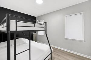 a bedroom with two bunk beds and a window at Epic Spa & Play Retreat NYC EWR Sleeps 30! in Bayonne