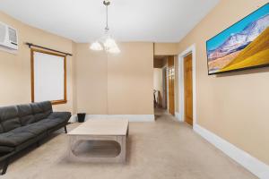 a living room with a couch and a table at Epic Spa & Play Retreat NYC EWR Sleeps 30! in Bayonne