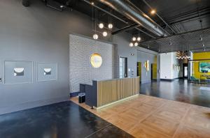 a large room with a lobby with wood floors at Muse Nashville in Nashville