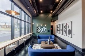 a living room with blue furniture and a table at Muse Nashville in Nashville