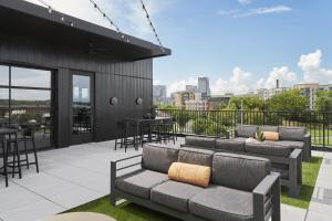 a patio with two couches and a table and chairs at Muse Nashville in Nashville