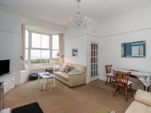 a living room with a couch and a table at Sea Front Apartment in Hornsea