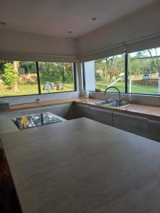 a kitchen with a sink and a large window at Casa de vacaciones in Dos de Mayo