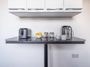a counter top with a coffee maker and fruits on it at 3 BDRM - Bright & Spacious Home in North Shields