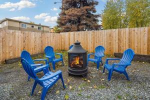 a group of blue chairs around a fire pit at Cottage near restaurants and trails Slumber Village 5 in Anchorage