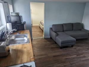 a living room with a couch and a sink at Cottage near restaurants and trails Slumber Village 5 in Anchorage