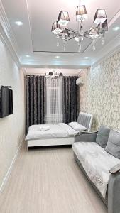 a living room with a bed and a couch at Elizavetta in Bishkek